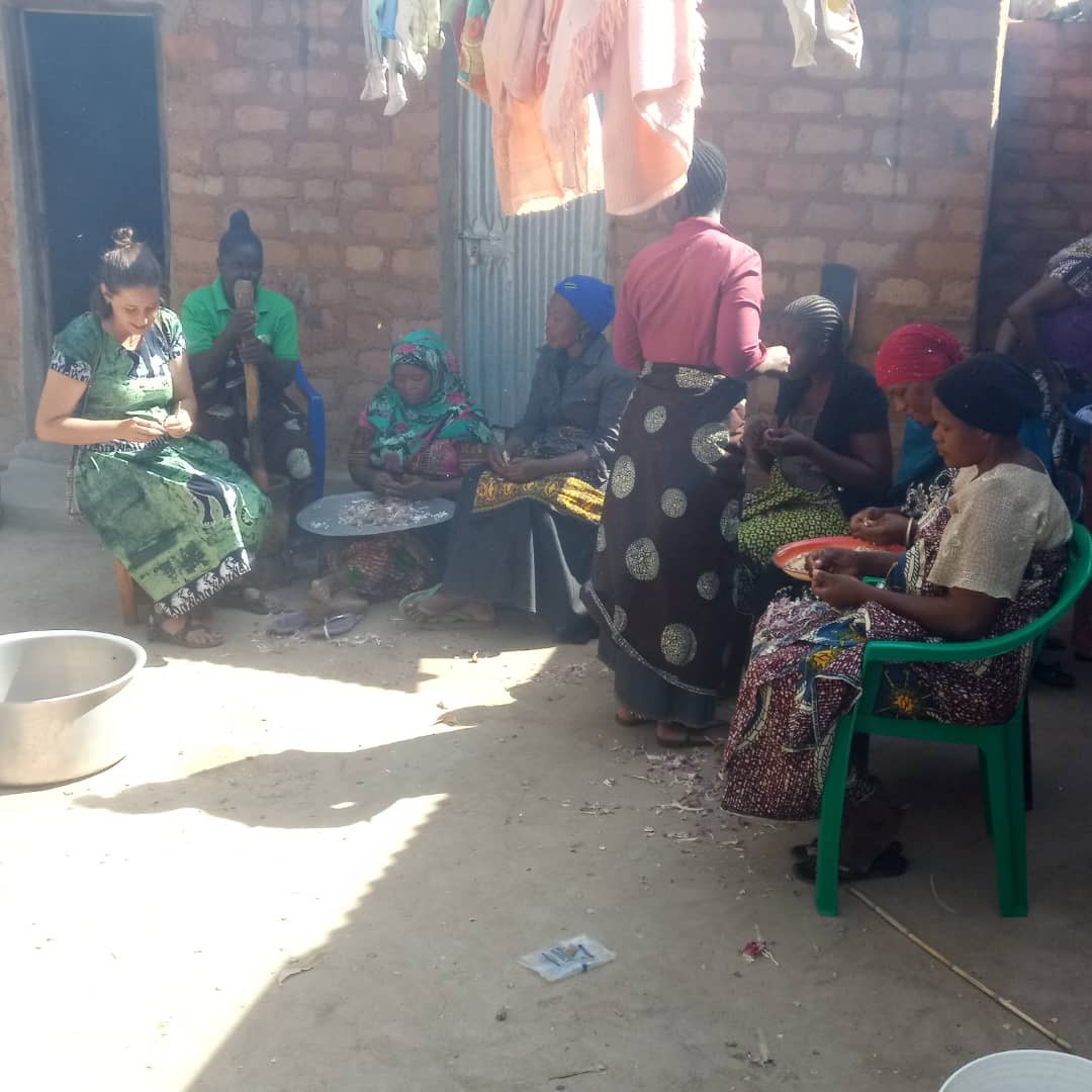 Kenna Dieffenwierth cooking with some local women in her community in Tanzania